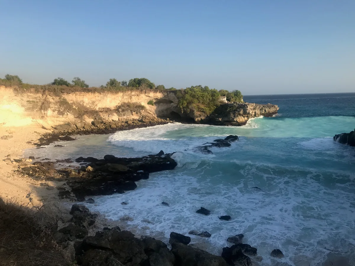 Waves breaking against the rocky coast of Nusa Ceningan